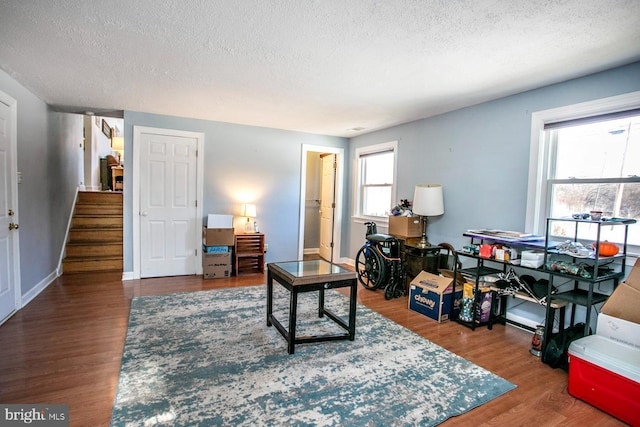 sitting room with wood-type flooring and a textured ceiling