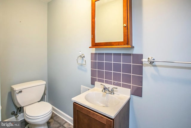 bathroom with decorative backsplash, toilet, and vanity