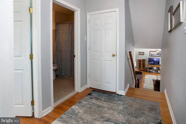 hall with hardwood / wood-style floors