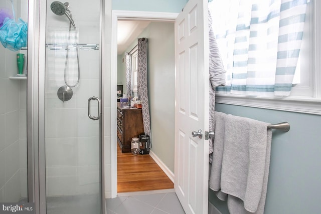 bathroom featuring tile patterned flooring and a shower with shower door