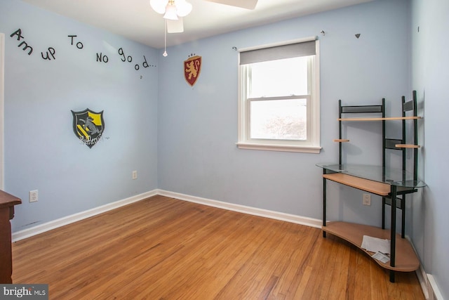 interior space with ceiling fan and wood-type flooring