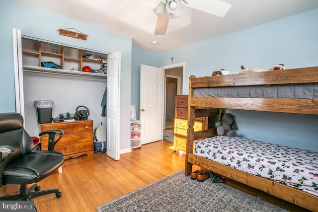 bedroom featuring ceiling fan, a closet, and light hardwood / wood-style flooring