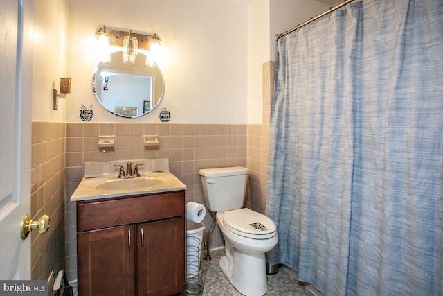 bathroom featuring vanity, tile walls, tile patterned flooring, toilet, and curtained shower