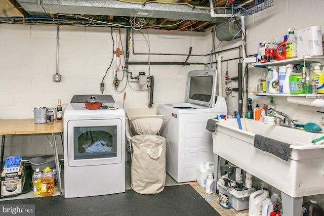 laundry area with washing machine and dryer and sink