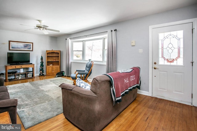 living room with hardwood / wood-style flooring and ceiling fan