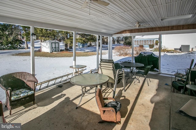 view of patio featuring grilling area, ceiling fan, and a shed