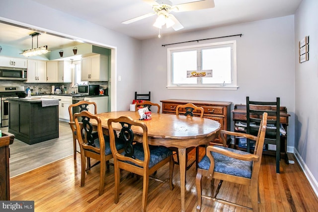 dining room featuring ceiling fan and light hardwood / wood-style flooring