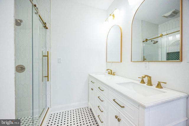 bathroom featuring vanity and a shower with shower door