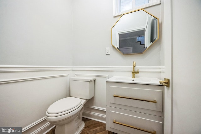 bathroom featuring hardwood / wood-style floors, vanity, and toilet