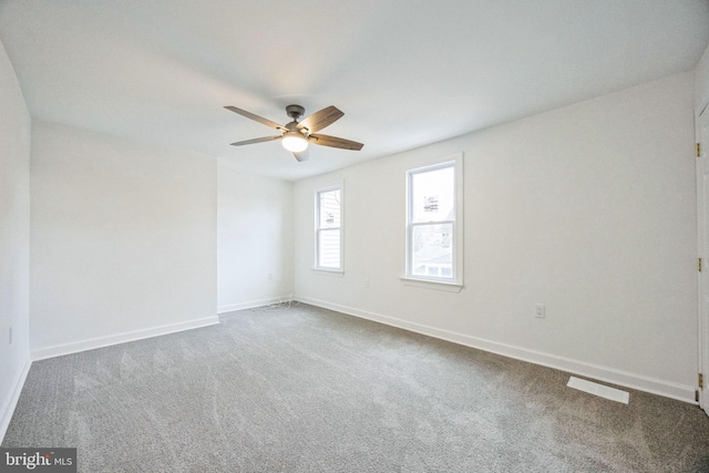 carpeted spare room with ceiling fan