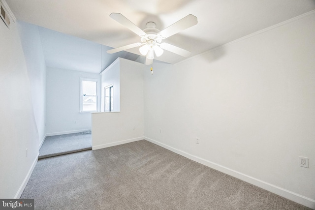 carpeted empty room featuring lofted ceiling, ceiling fan, and ornamental molding