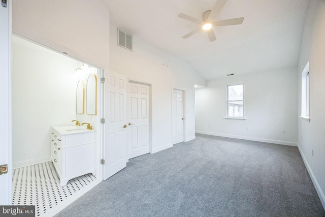 unfurnished bedroom featuring ceiling fan, light colored carpet, and lofted ceiling