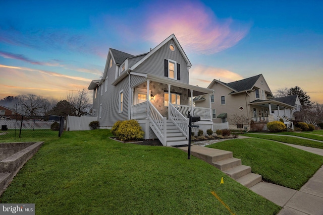 view of front of house with a lawn and covered porch