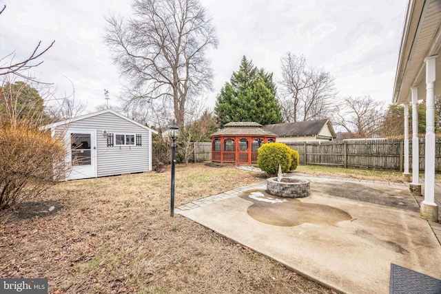 view of yard featuring a gazebo, a patio, and a shed