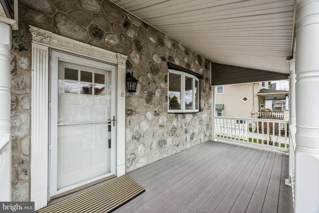 property entrance with a porch and a garage