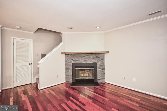 unfurnished living room with hardwood / wood-style flooring, ornamental molding, and a fireplace