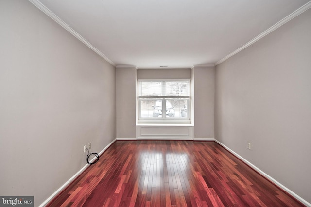 spare room featuring dark wood-type flooring and ornamental molding