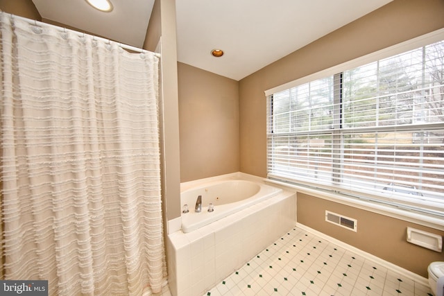 bathroom featuring a relaxing tiled tub