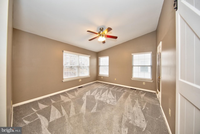 unfurnished room with carpet, ceiling fan, and vaulted ceiling