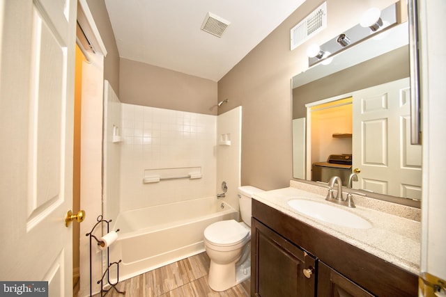 full bathroom featuring hardwood / wood-style floors, vanity, toilet, and bathing tub / shower combination