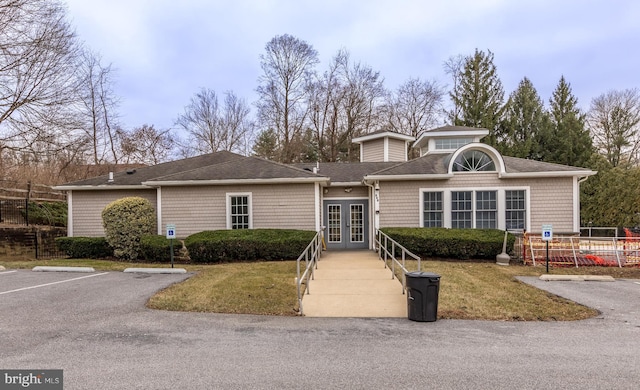 view of front of home featuring a front yard and french doors