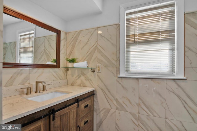 bathroom featuring tile walls, plenty of natural light, and vanity