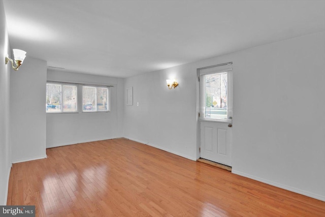 entrance foyer featuring baseboards and wood finished floors