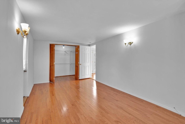 empty room with light wood-style floors and baseboards