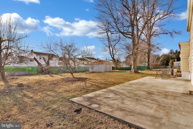 view of yard with a storage shed, central AC unit, a patio, a fenced backyard, and an outdoor structure