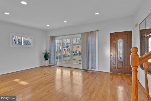 foyer with stairway, wood finished floors, and recessed lighting