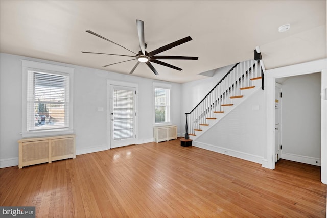 entryway featuring radiator heating unit, ceiling fan, and hardwood / wood-style floors