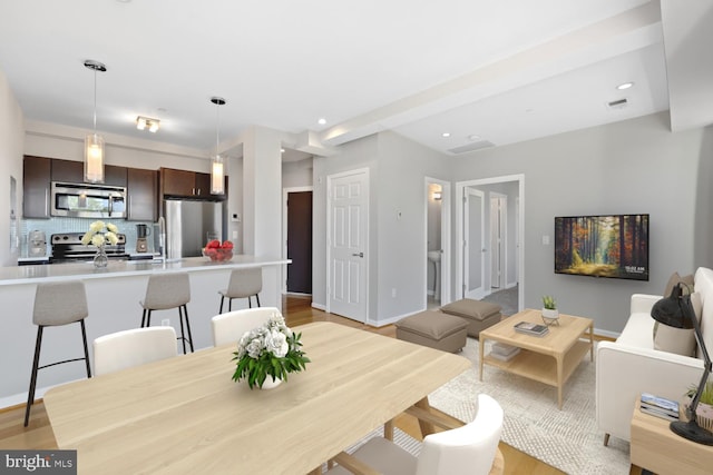 dining space with light hardwood / wood-style floors