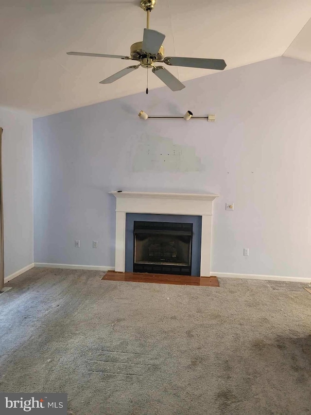 unfurnished living room featuring ceiling fan, vaulted ceiling, and carpet flooring