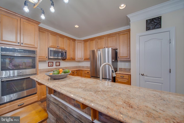 kitchen featuring light stone counters, ornamental molding, sink, and appliances with stainless steel finishes