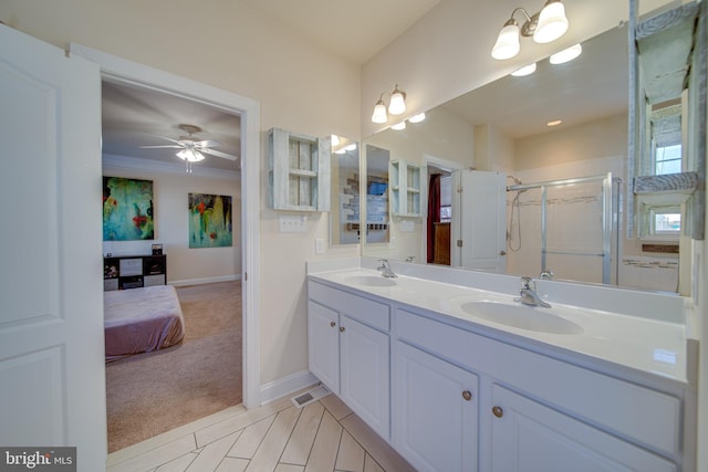 bathroom with vanity, a shower with door, and ceiling fan