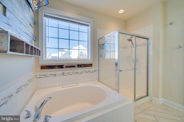 bathroom featuring tile patterned flooring and separate shower and tub