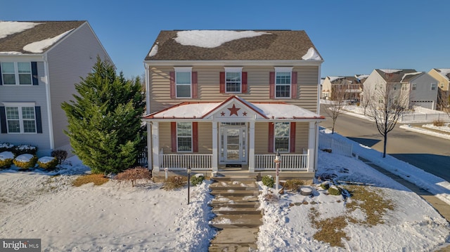 view of front of property featuring covered porch and fence