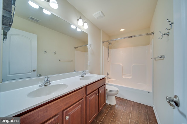 full bathroom with vanity, shower / bath combination, and toilet