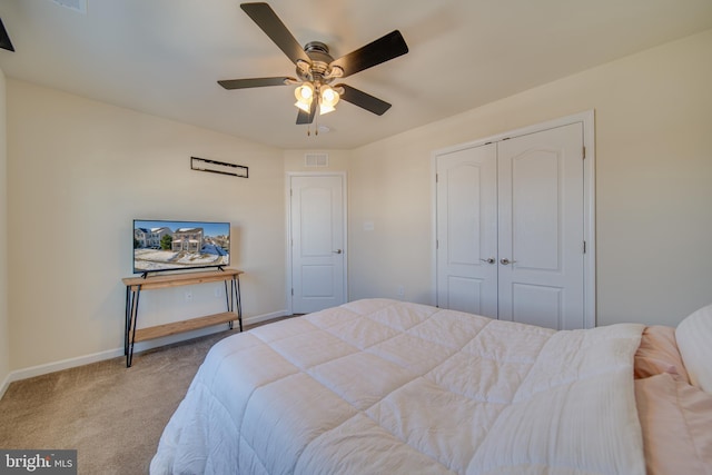 carpeted bedroom with a closet and ceiling fan