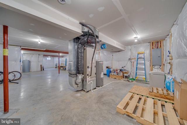 basement featuring electric panel and water heater