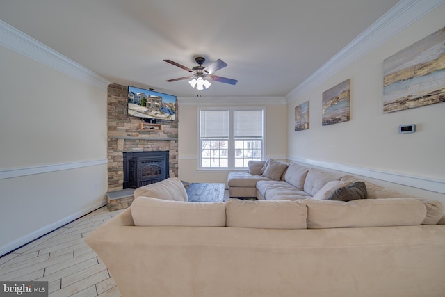 living room featuring a wood stove, ceiling fan, and ornamental molding