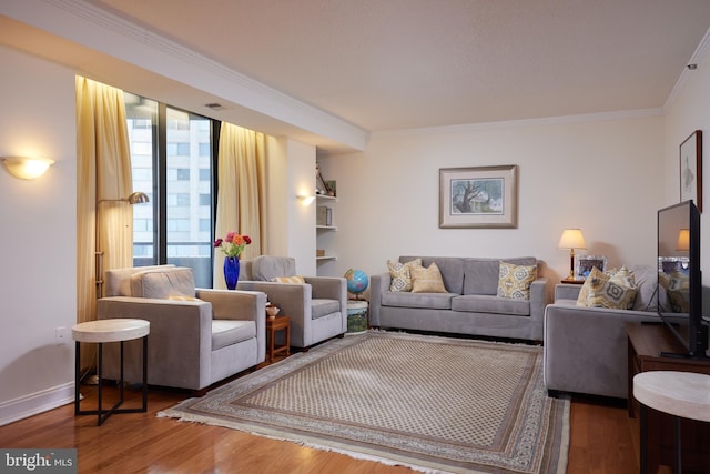 living room with wood-type flooring and crown molding