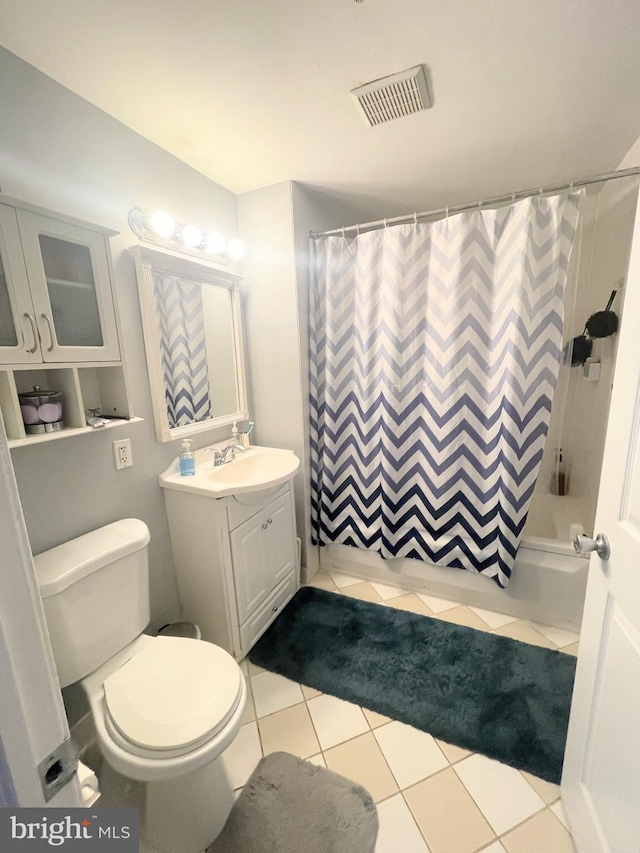 full bathroom featuring tile patterned floors, vanity, toilet, and shower / bathtub combination with curtain