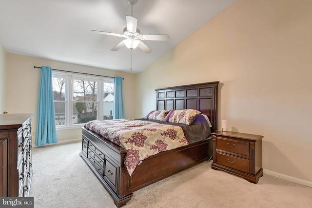 carpeted bedroom with ceiling fan and lofted ceiling