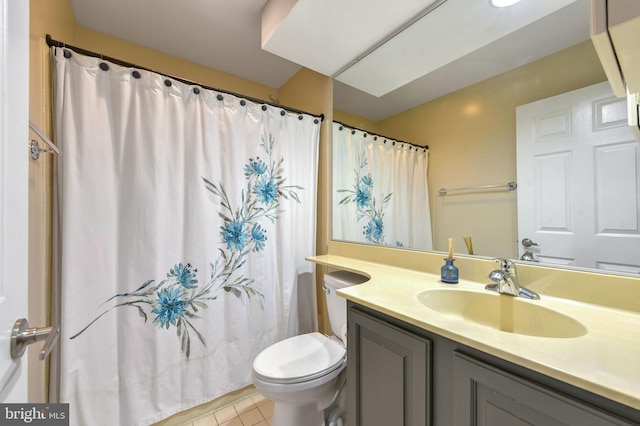 bathroom with tile patterned flooring, vanity, and toilet