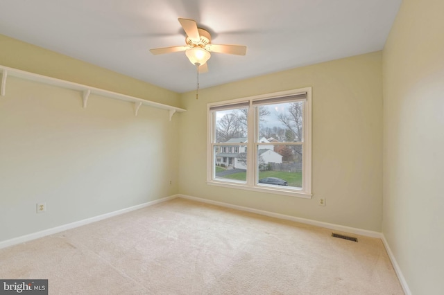 carpeted empty room with ceiling fan