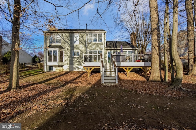 rear view of property with a wooden deck