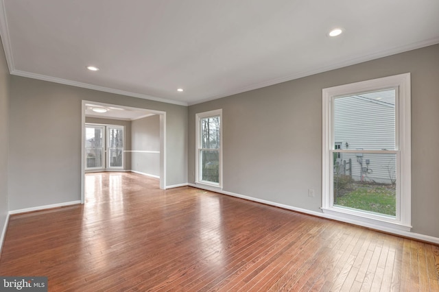 spare room with crown molding and hardwood / wood-style floors