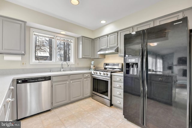 kitchen with stainless steel appliances, gray cabinets, and sink