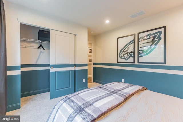 bedroom with light colored carpet and a closet